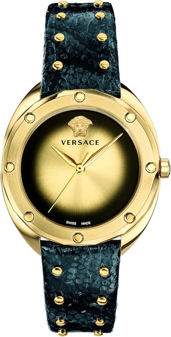 Versace watch with a round gold-tone case, gold dial, and a textured dark blue strap adorned with gold studs, shown on a white background.