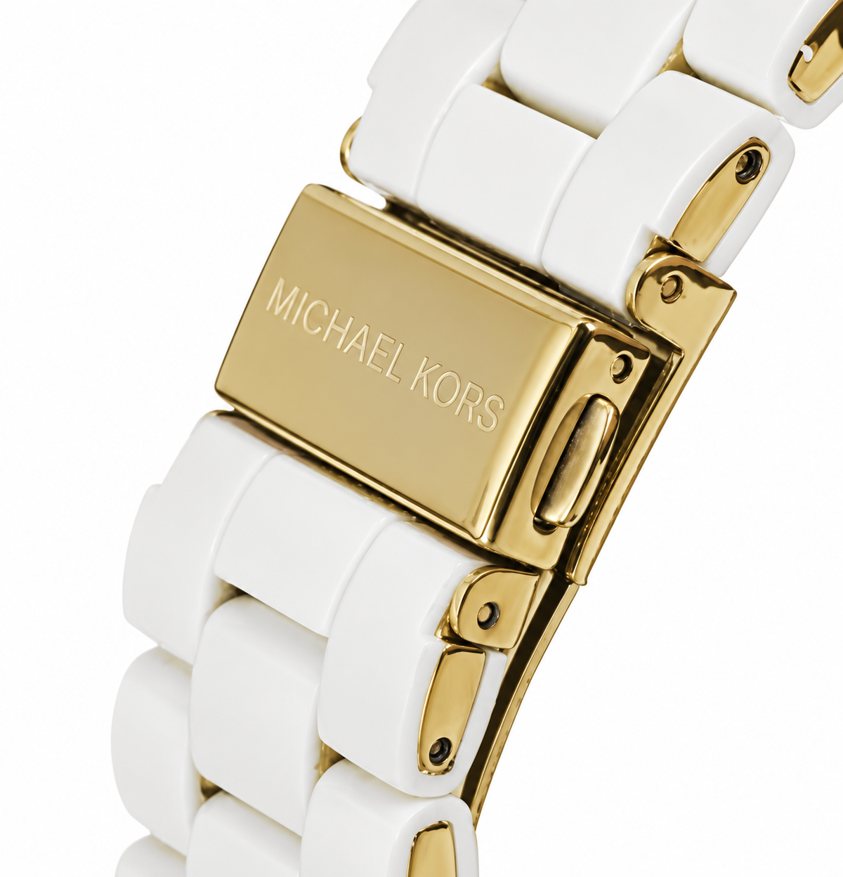 Close-up of a Michael Kors watch band with white ceramic links and a gold-tone clasp engraved with the Michael Kors name.