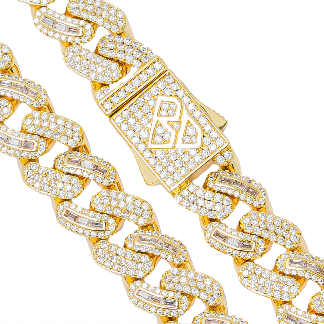 Close-up of gold Cuban chain clasp and baguette crystal detailing