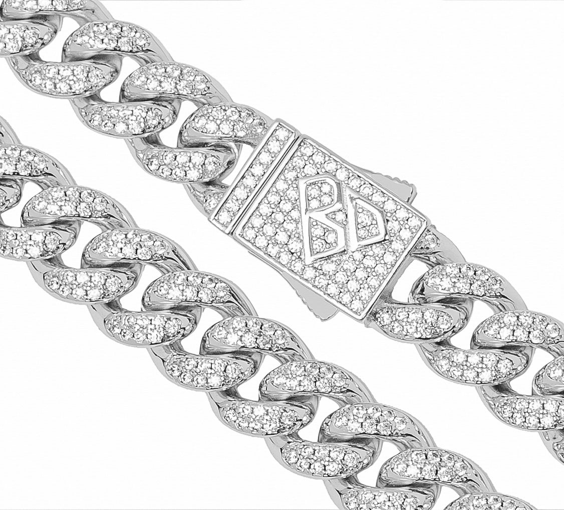 Close-up detail of Cuban link chain with iced-out diamond cuts and decorative clasp