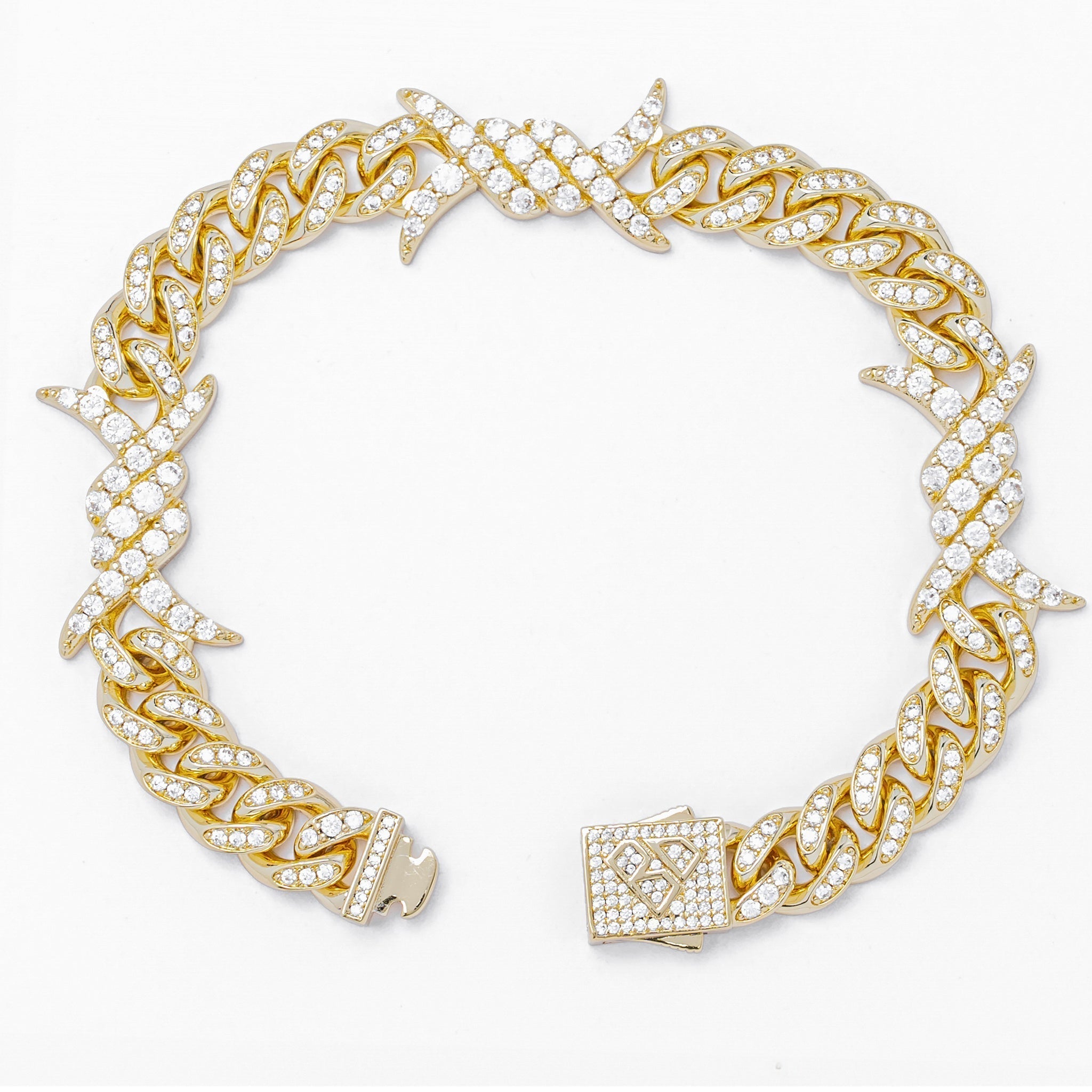 Gold spiked horns bracelet with iced-out cubic zirconia, angled side view showing clasp