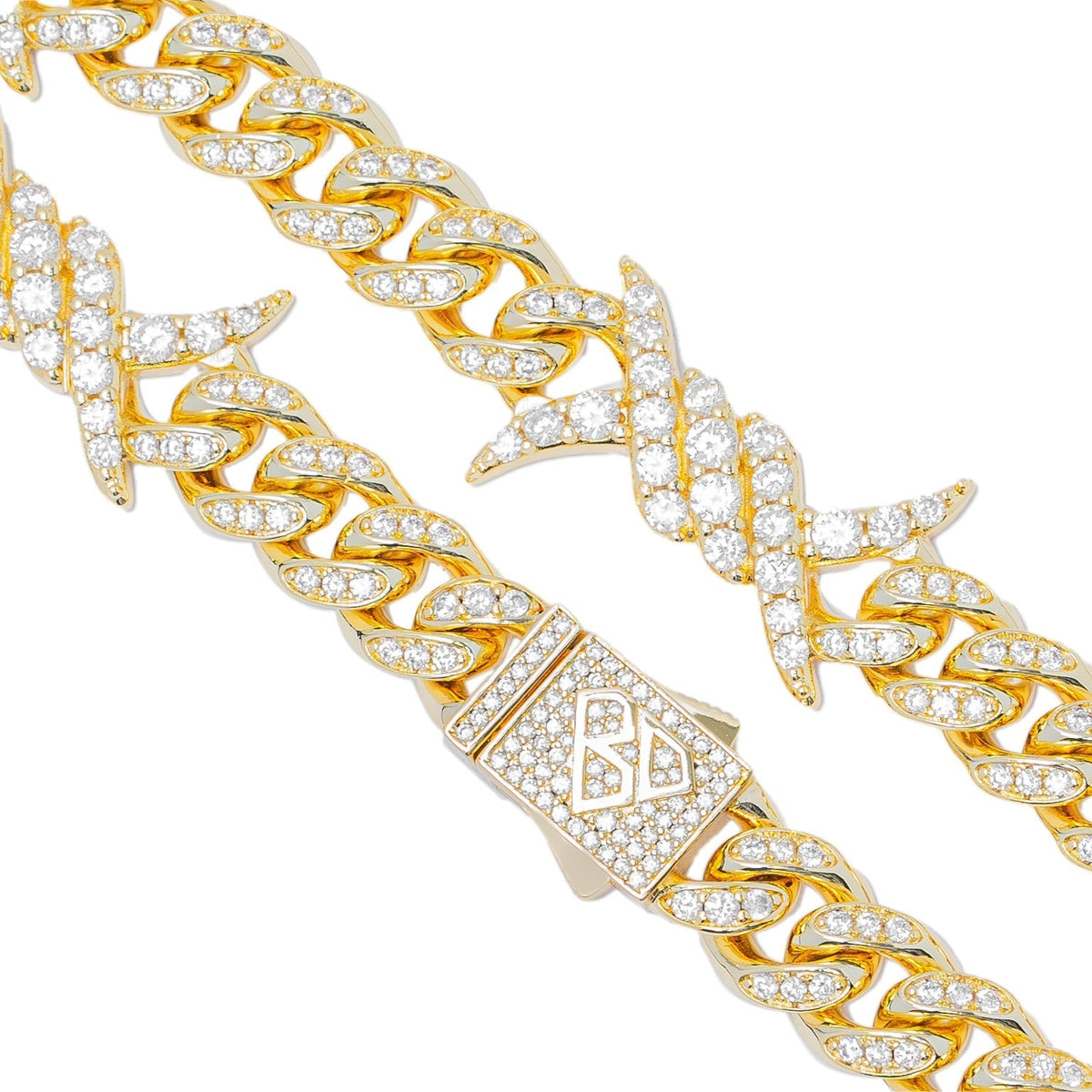 Close-up detail of 10MM spiked horn charms and Cuban curb links on gold chain
