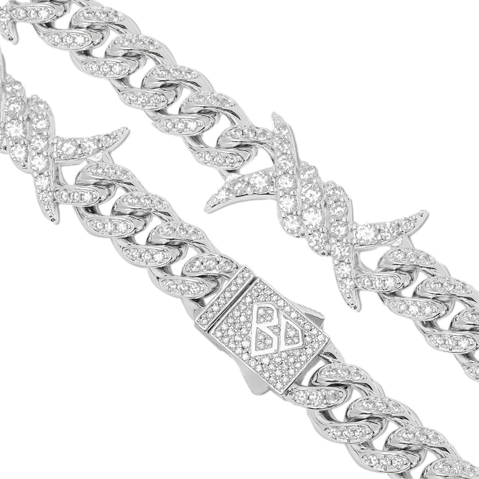 Detailed view of spiked horn links and Cuban link structure on iced out silver chain