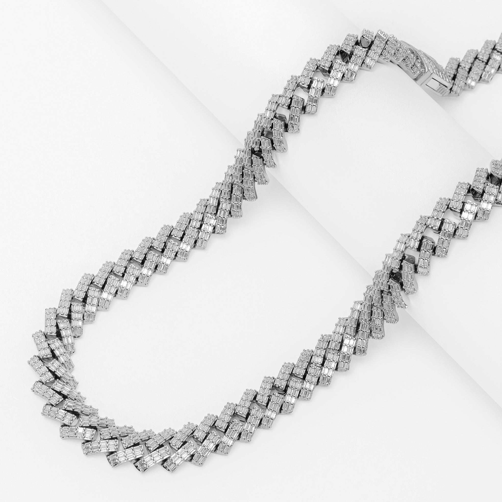 Big Daddy 12MM baguette Cuban diamond silver chain laid flat on white surface
