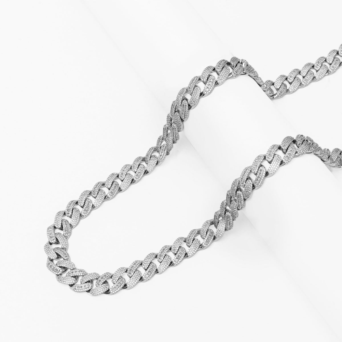 Two Big Daddy 12MM Cuban chains laid out showing full length and link structure