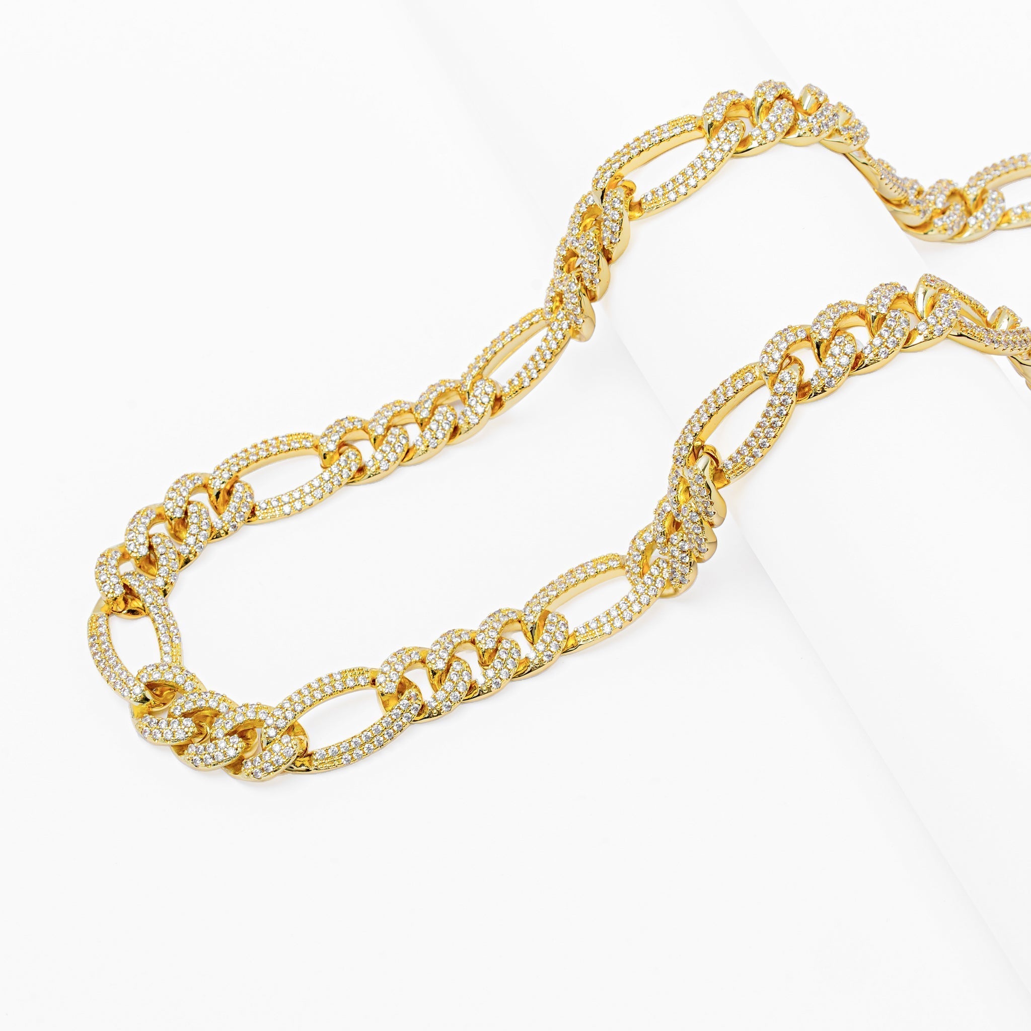 Layered view of 12MM iced-out Figaro gold chain links