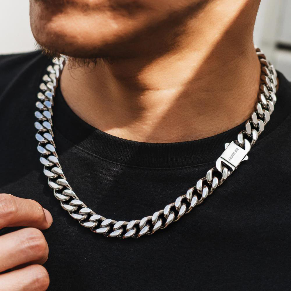 12mm silver Cuban chain worn on neck with box clasp visible
