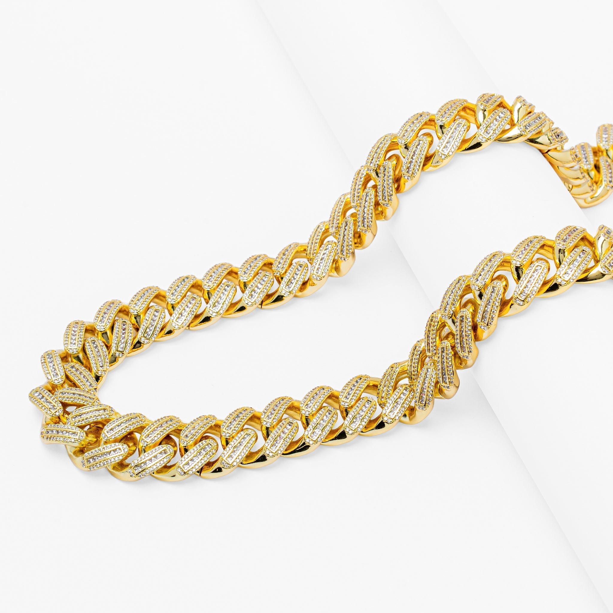 Side view of 18MM gold Cuban link chain with full iced out baguette diamond coverage