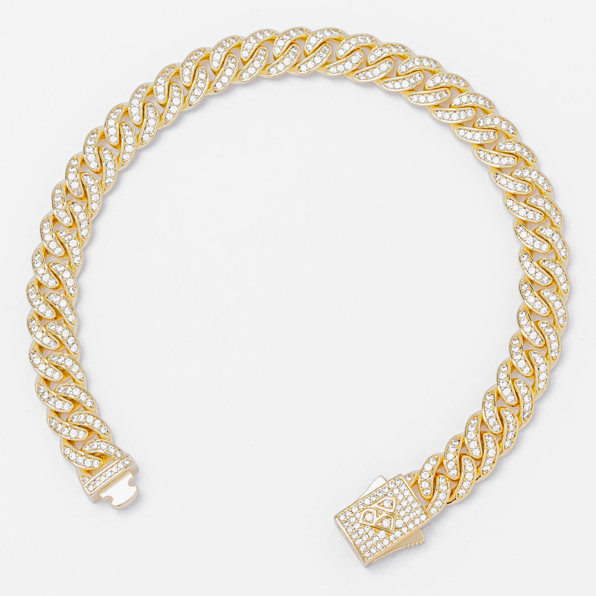 Cuban gold chain bracelet showcasing spiral link pattern with diamond-encrusted box clasp