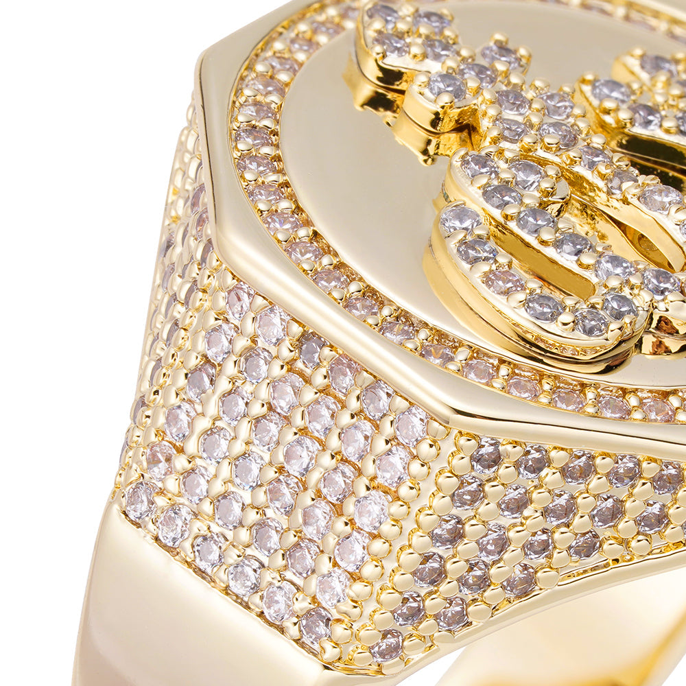 Close-up detail of iced out diamonds and gold accents on ring top