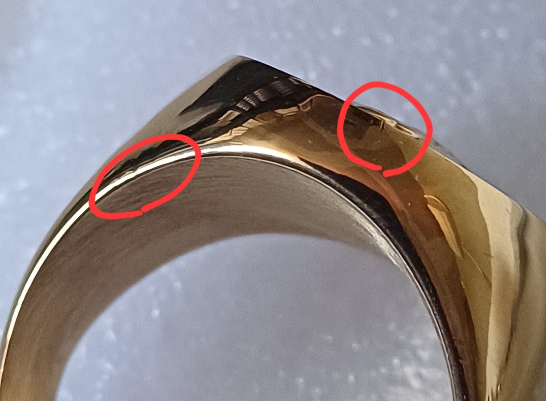 Ring surface detail showing defect areas circled in red on band