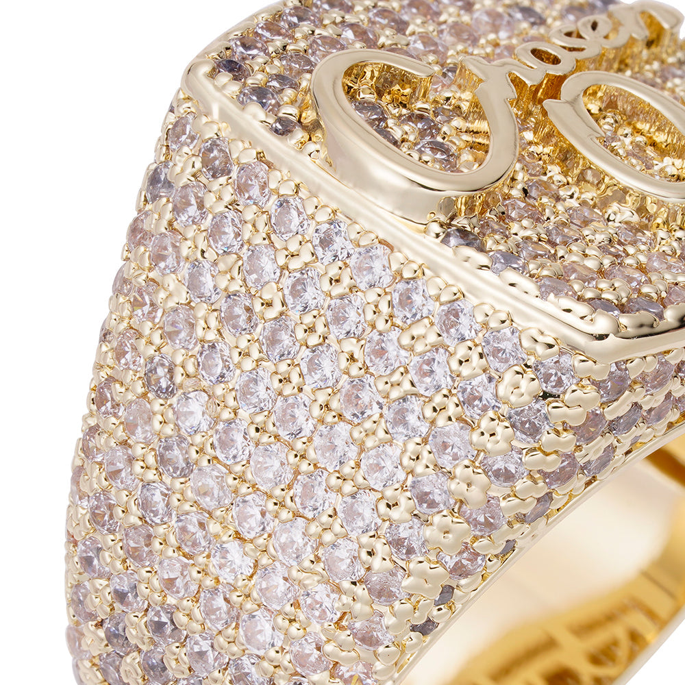 Close-up detail of iced out pavé cubic zirconia coverage and gold OO logo on ring