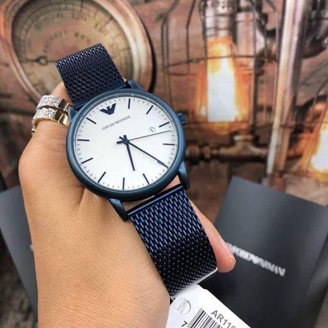 Emporio Armani Luigi watch worn on wrist with blue mesh strap and white dial