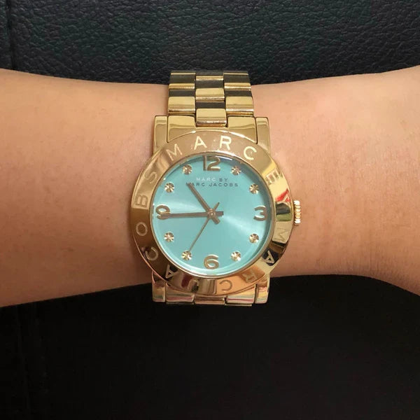 Marc by Marc Jacobs Amy watch worn on wrist showing blue dial and gold-tone bracelet