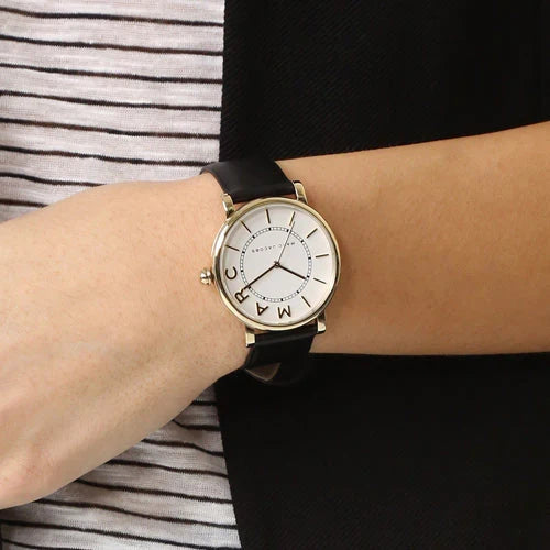 Marc Jacobs Classic Mini watch worn on wrist, white dial with gold-tone case and black leather strap