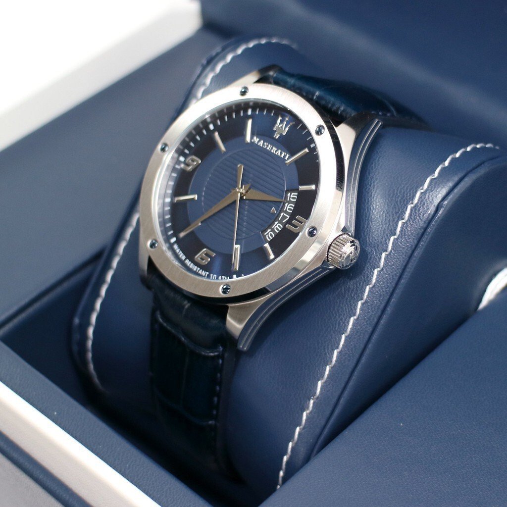 Angled view of Maserati Circuito watch showing blue dial and stainless steel bezel on blue cushion