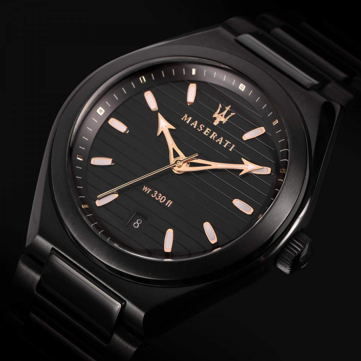 Close-up of black dial showing Maserati branding, gold hands, and water resistance marking