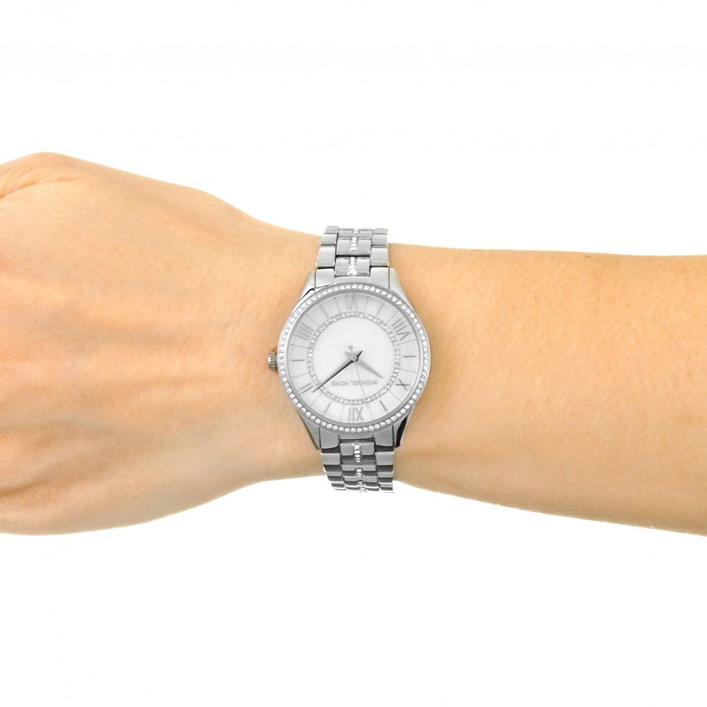 Michael Kors Lauryn white dial watch worn on wrist with stainless steel bracelet
