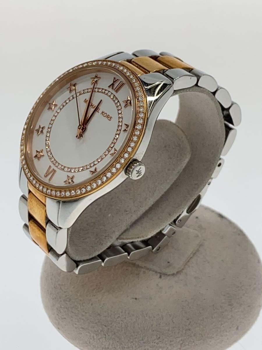 Side angle view of Michael Kors MK4483 watch on display stand