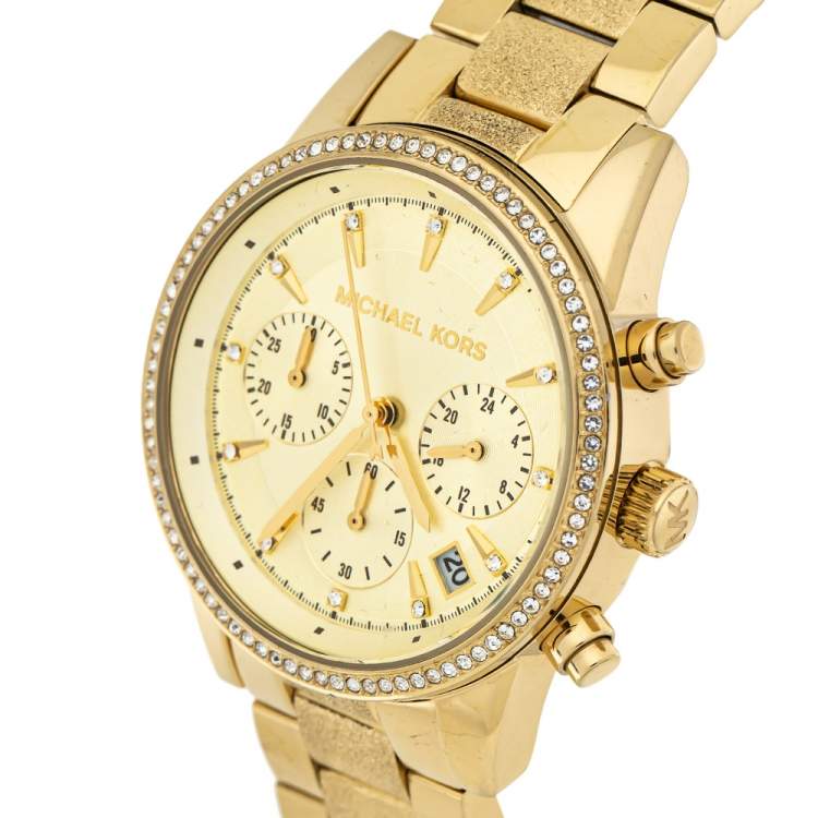 Three-quarter view of Michael Kors Ritz chronograph showing gold tone case, bracelet, and crystal bezel