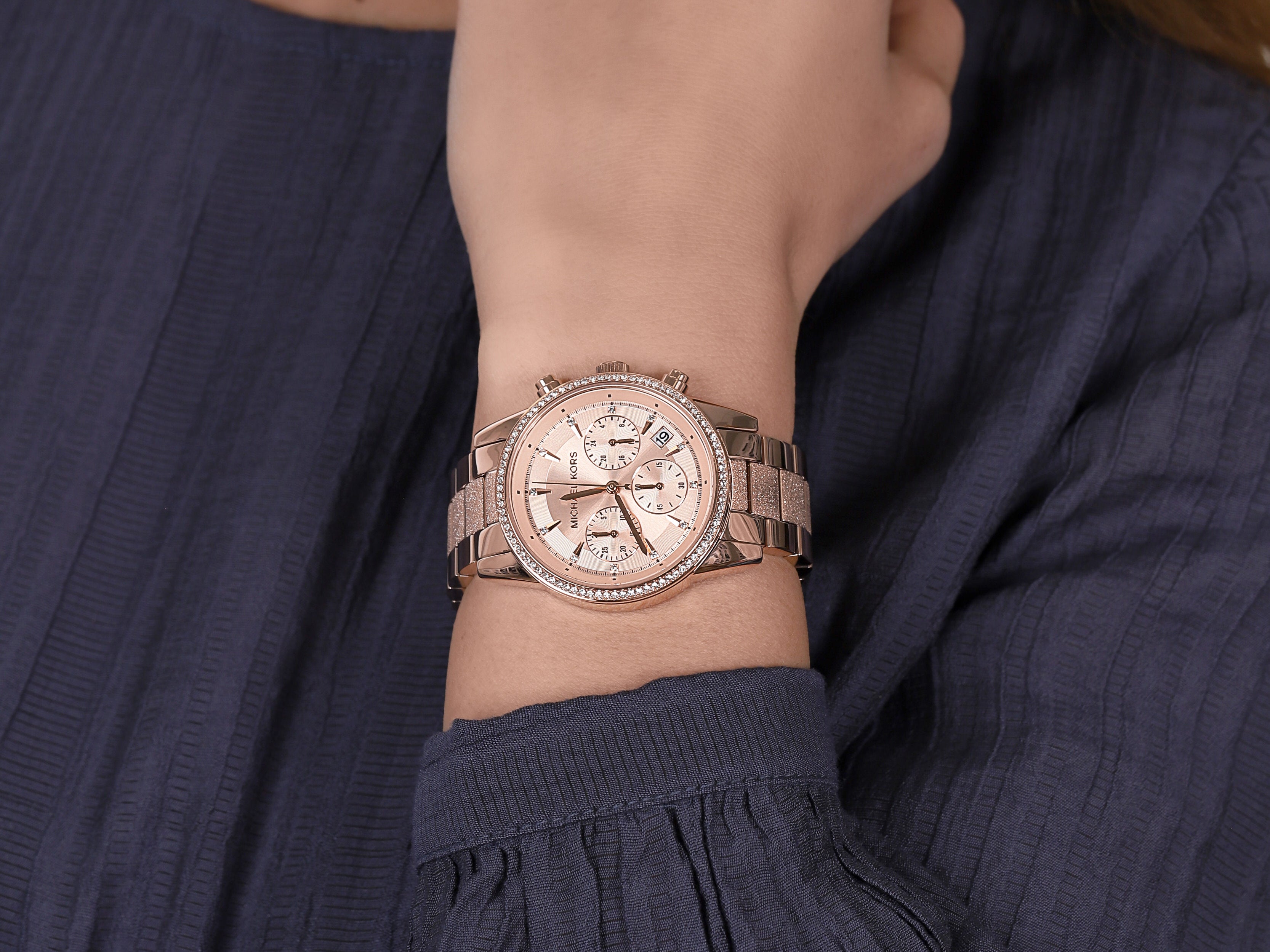 Michael Kors Ritz chronograph rose gold watch worn on wrist with rose gold bracelet