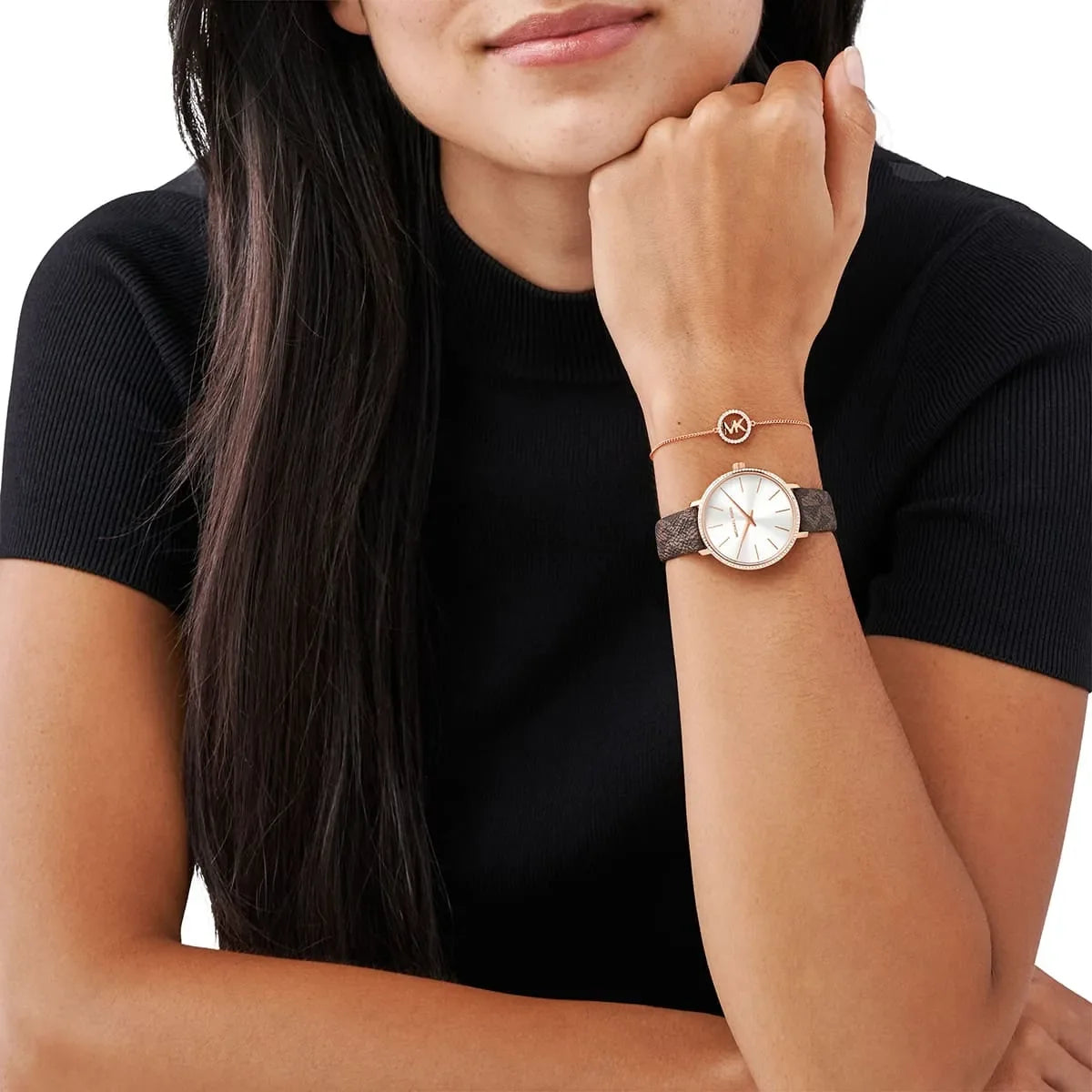 Michael Kors Pyper women's watch worn on wrist with white dial and brown leather strap