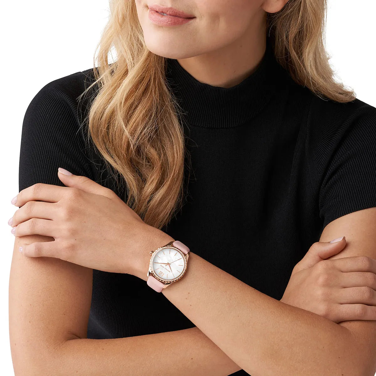 Michael Kors Layton women's watch worn on wrist showing white dial and pink leather strap