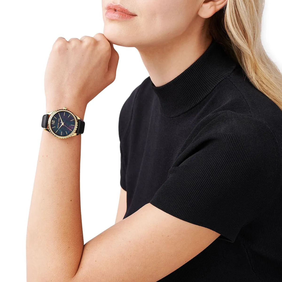Michael Kors Layton watch worn on wrist with black dial and gold-tone case