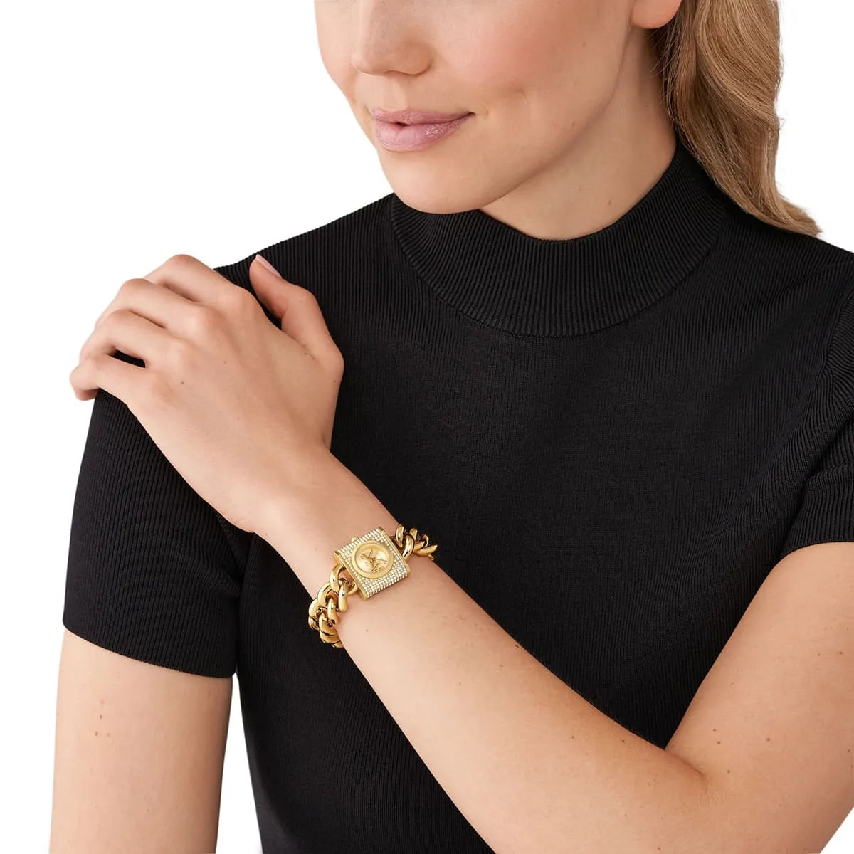 Michael Kors Chain Lock watch worn on wrist, displaying gold crystal-studded square case