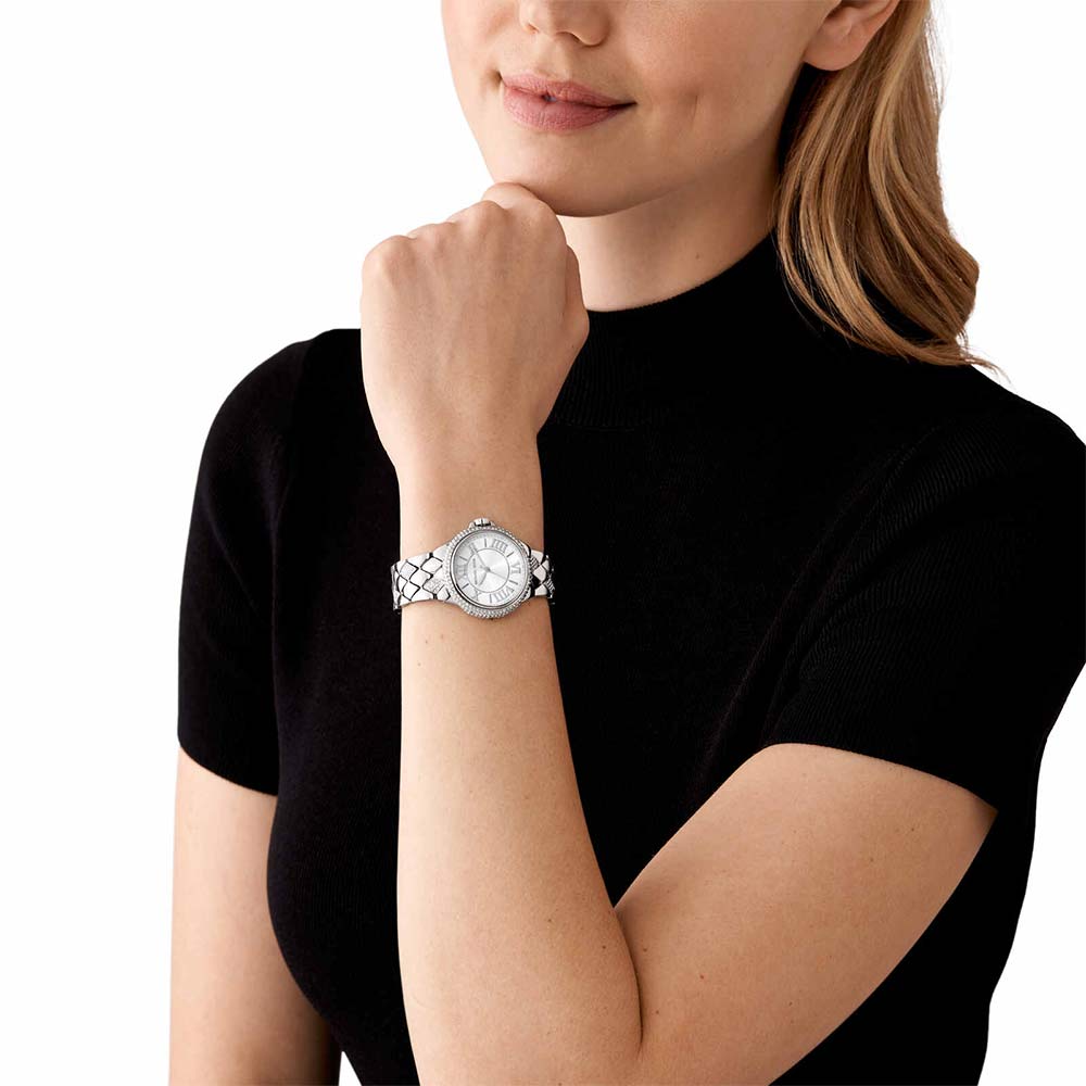 Michael Kors Mini Camille watch worn on woman's wrist, silver-tone with pavé details