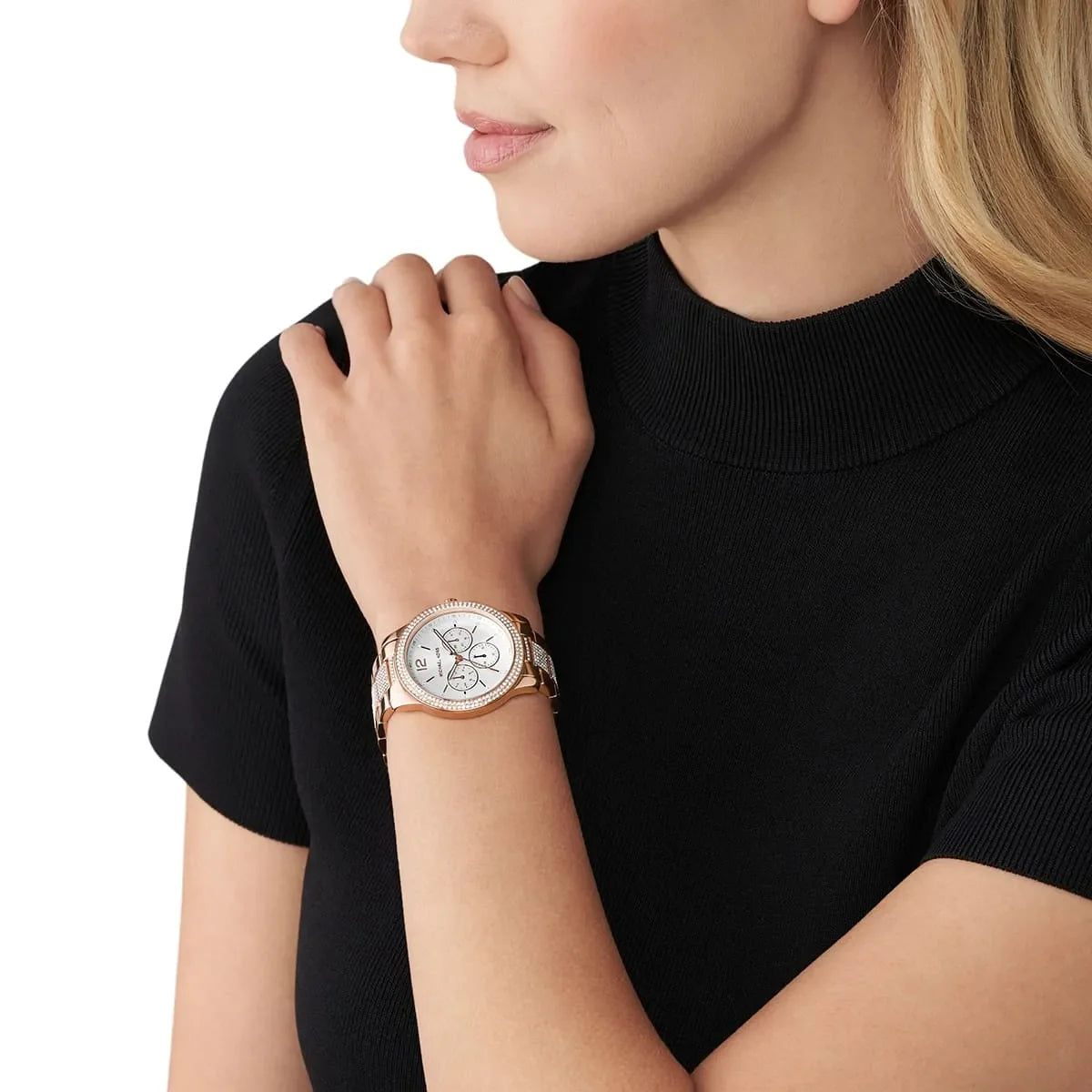 Michael Kors Oversized Tibby rose gold women's watch worn on wrist with silver chronograph dial