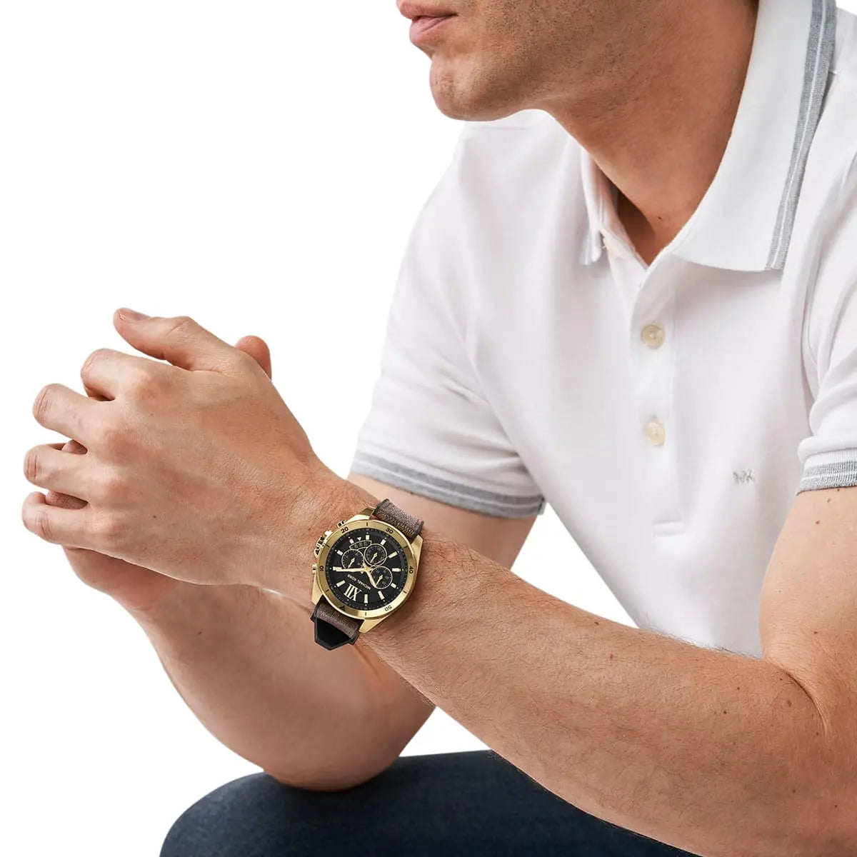Michael Kors Brecken gold chronograph watch worn on man's wrist