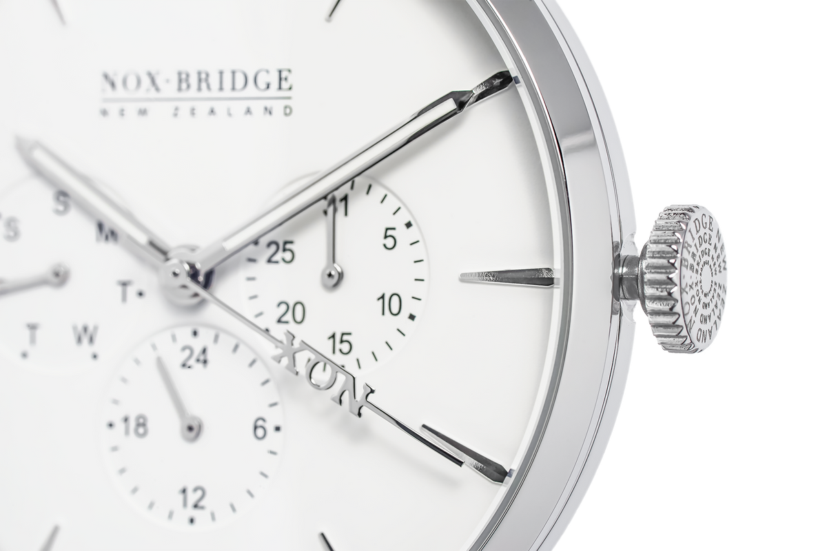Close-up of Alcyone watch dial showing subdials, applied indices, and textured crown