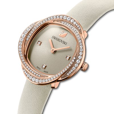 Crystalline Aura watch worn at angle showing rose gold case with crystal-set bezel detail