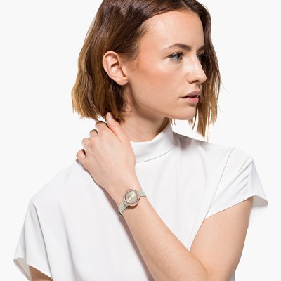 Swarovski Crystalline Aura women's watch worn on wrist with ivory dial and crystal bezel