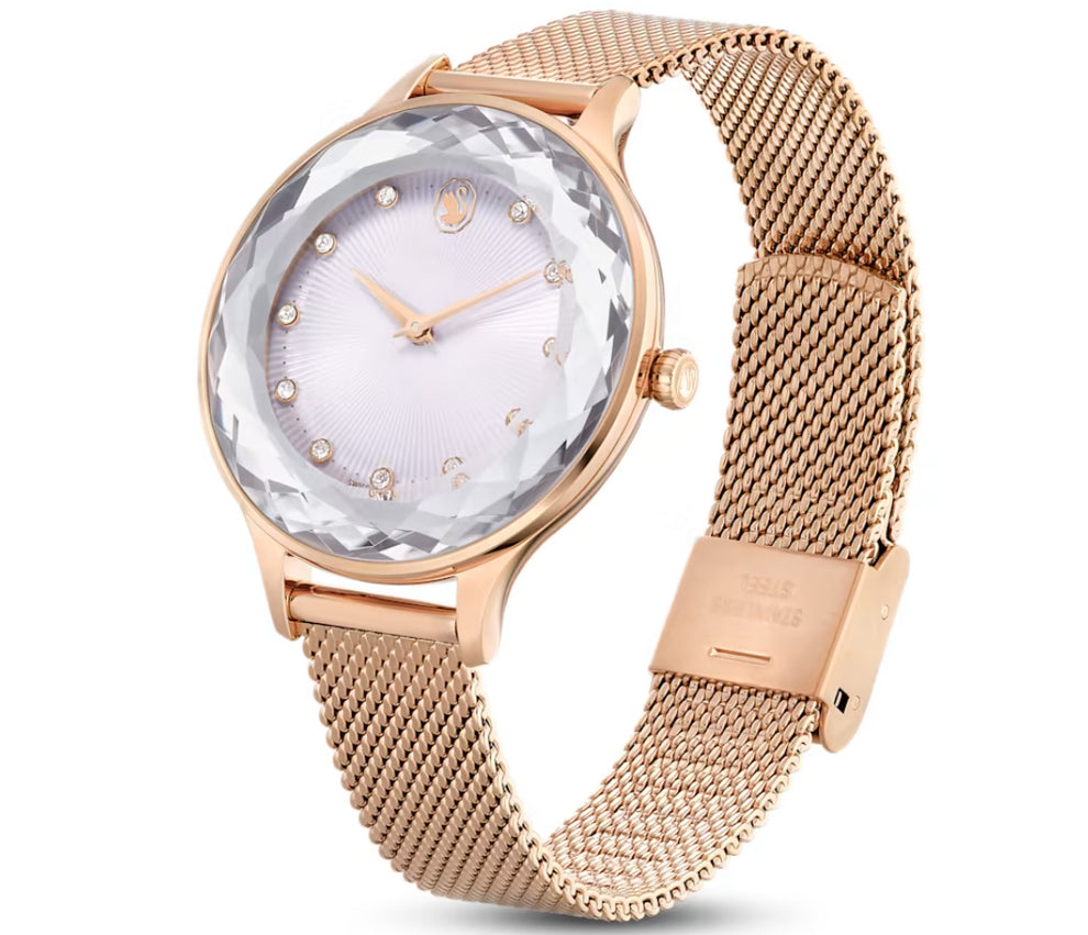 Swarovski Dextera watch on wrist showing crystal pave case, white dial with crystal hour markers, and mesh strap