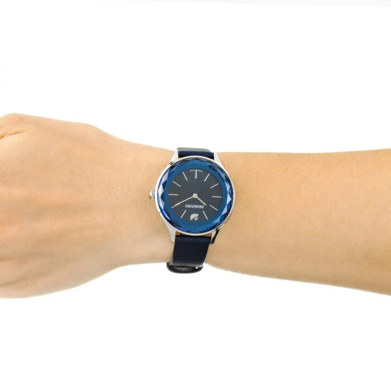 Swarovski Octea Nova watch worn on wrist with blue dial and navy leather strap