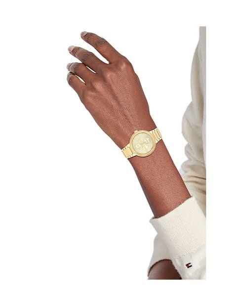 Tommy Hilfiger gold watch worn on wrist