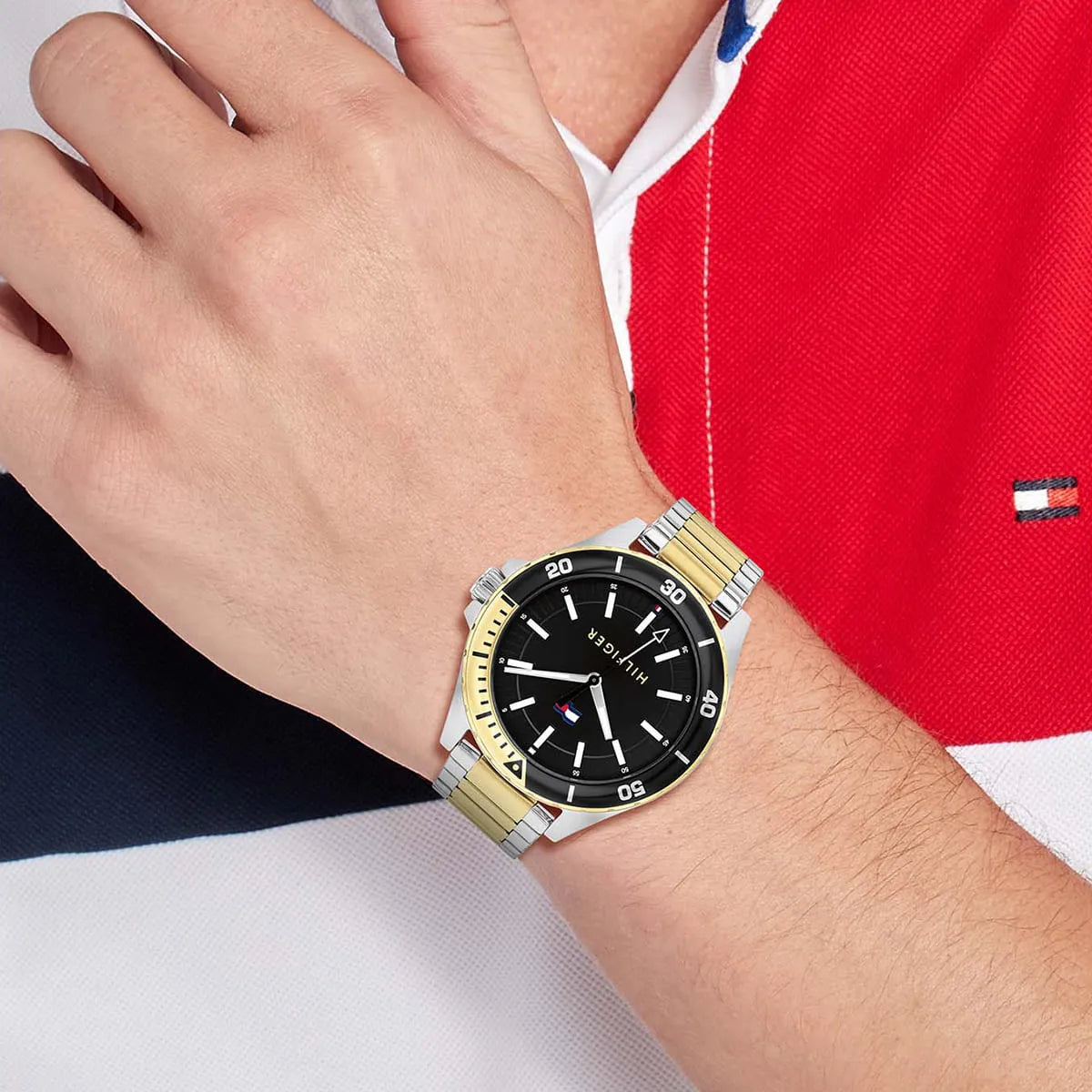 Tommy Hilfiger Baker watch worn on wrist showing black dial and two-tone bracelet