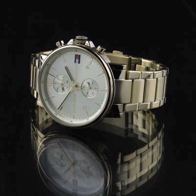 Tommy Hilfiger Daniel gold chronograph watch with reflection on dark surface