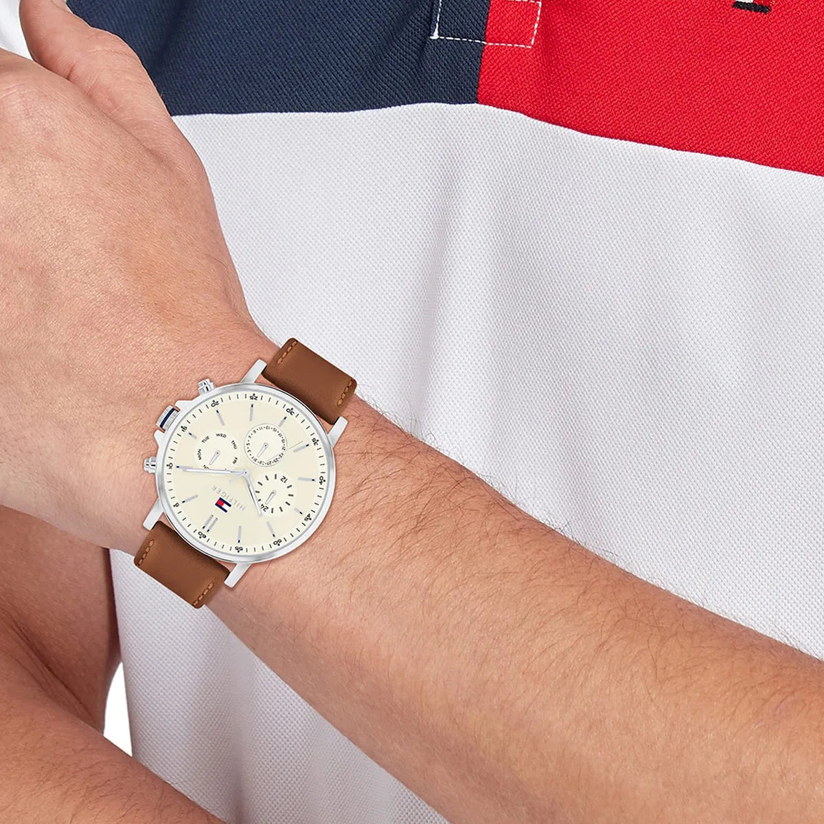 Tommy Hilfiger Tyson chronograph watch worn on wrist with brown leather strap and parchment dial