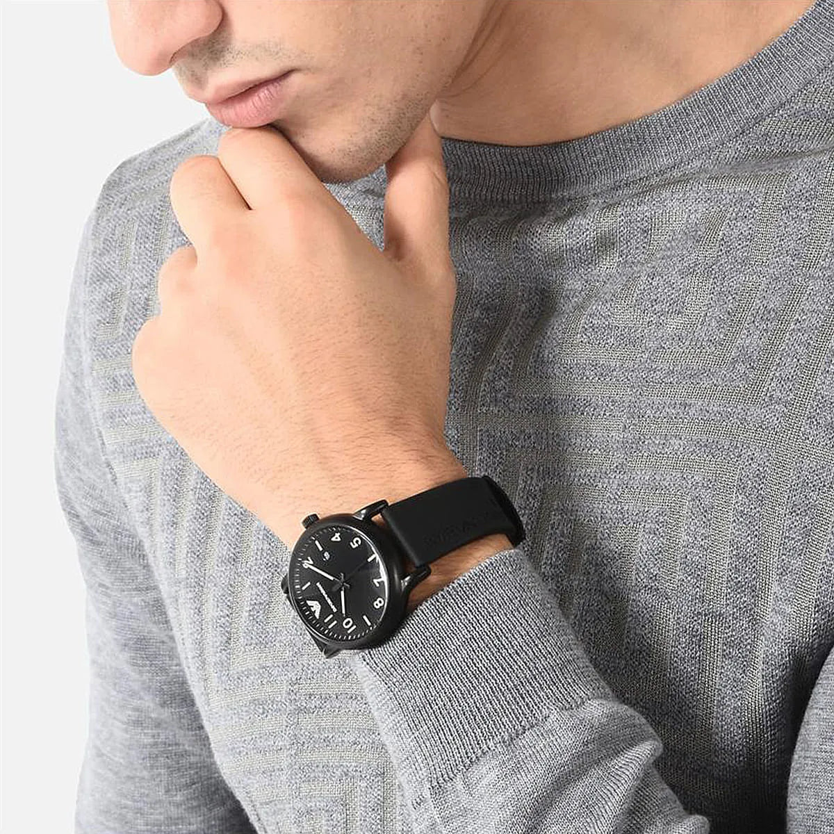 Man wearing Emporio Armani Luigi Slim black watch with black rubber strap on wrist