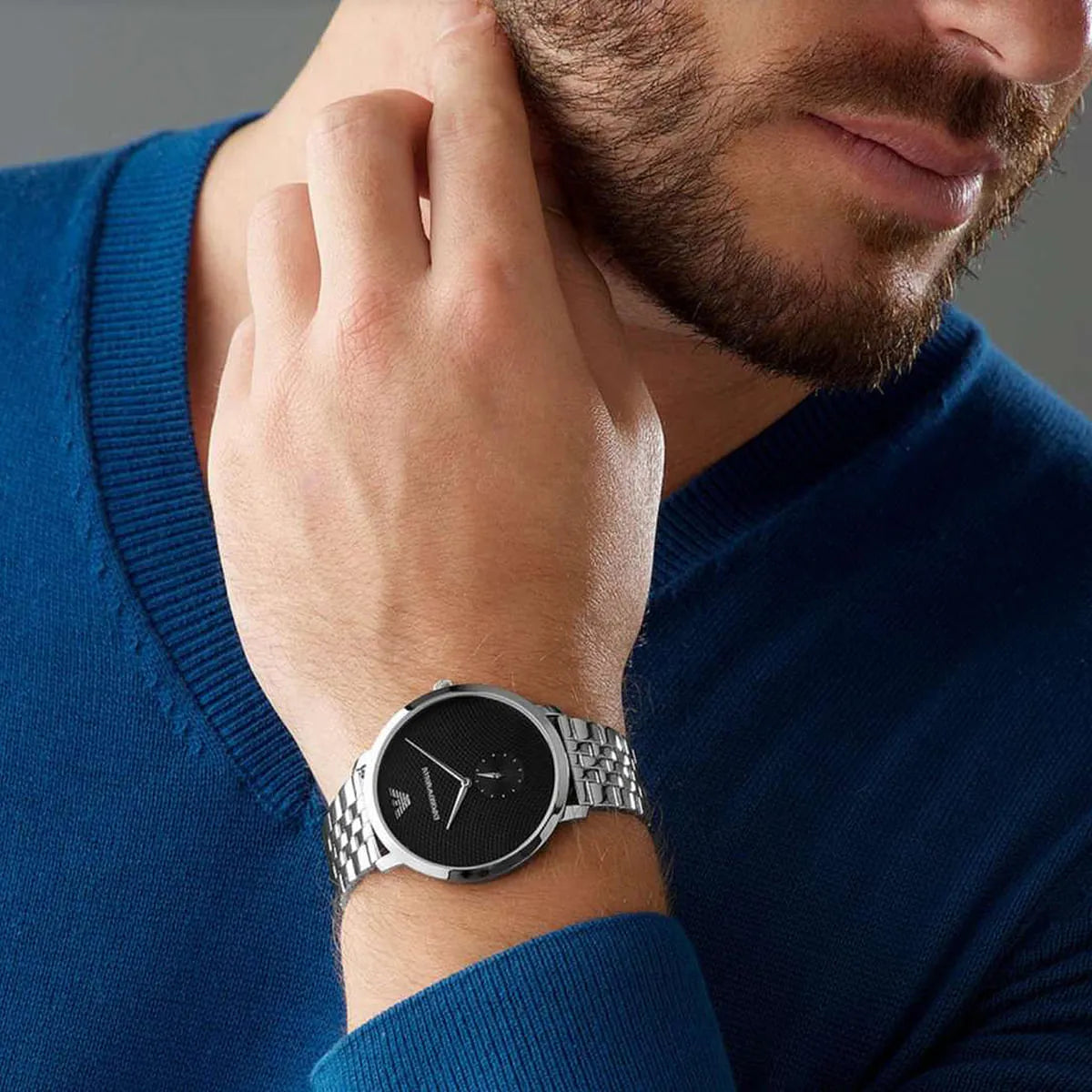 Emporio Armani AR11161 watch worn on wrist with black textured dial and silver bracelet