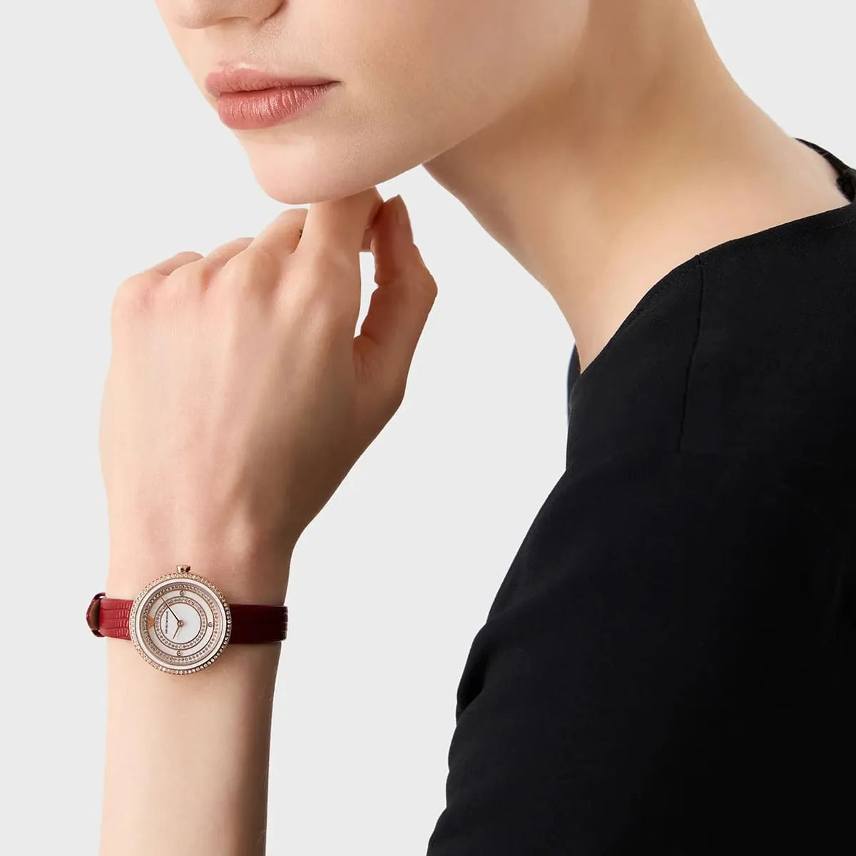 Emporio Armani Rosa watch on wrist showing white dial and red leather strap with rose gold case