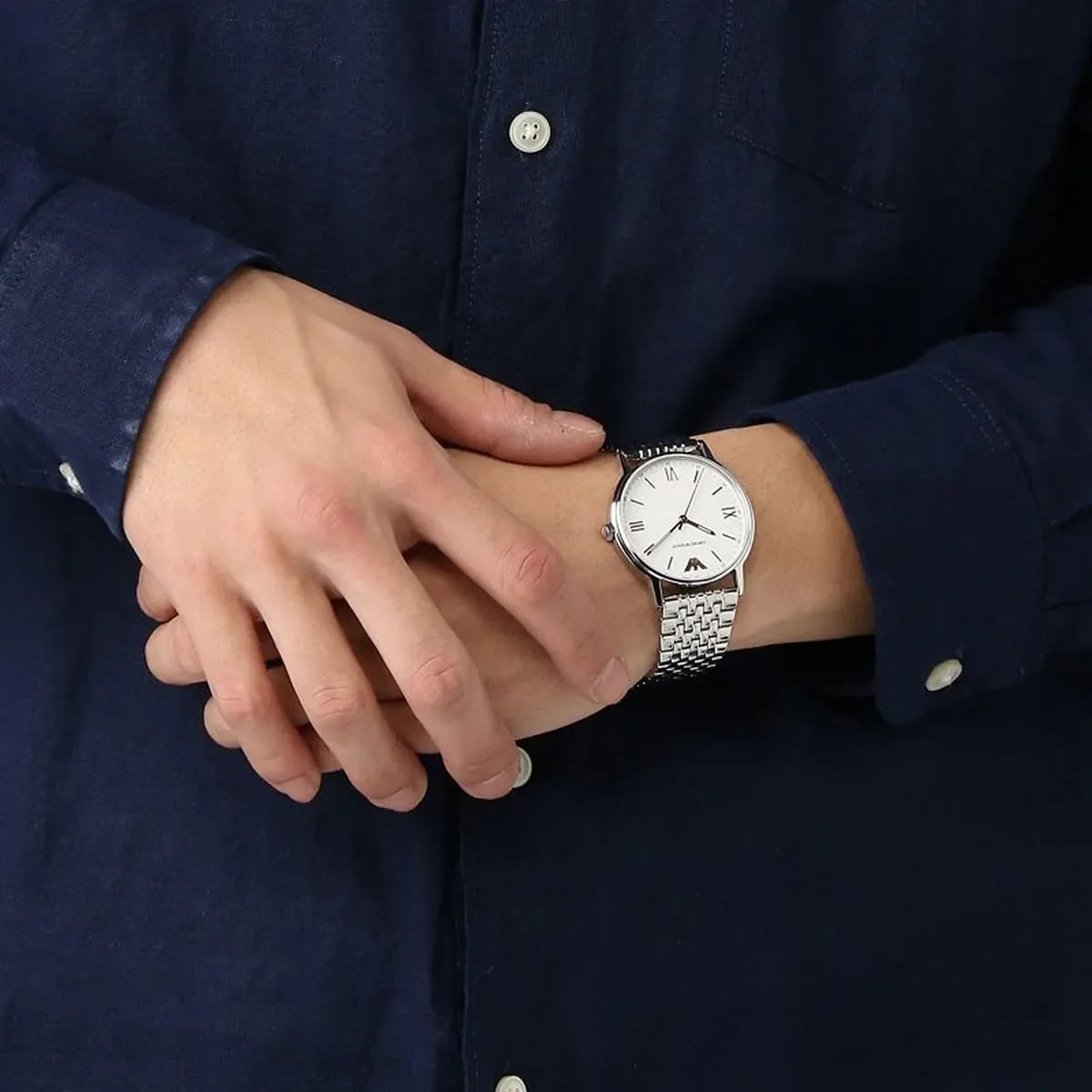 Emporio Armani Kappa watch worn on wrist with white dial and silver metal bracelet