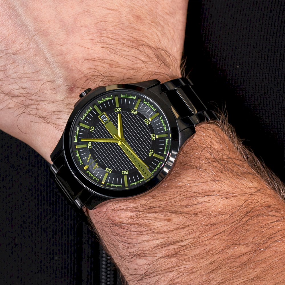 Armani Exchange AX2407 watch worn on wrist showing black case and yellow accents