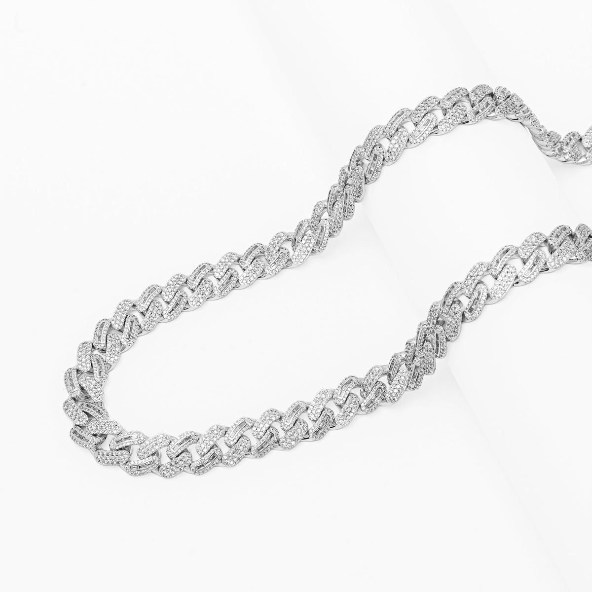 Two iced out silver Cuban chains displayed side by side