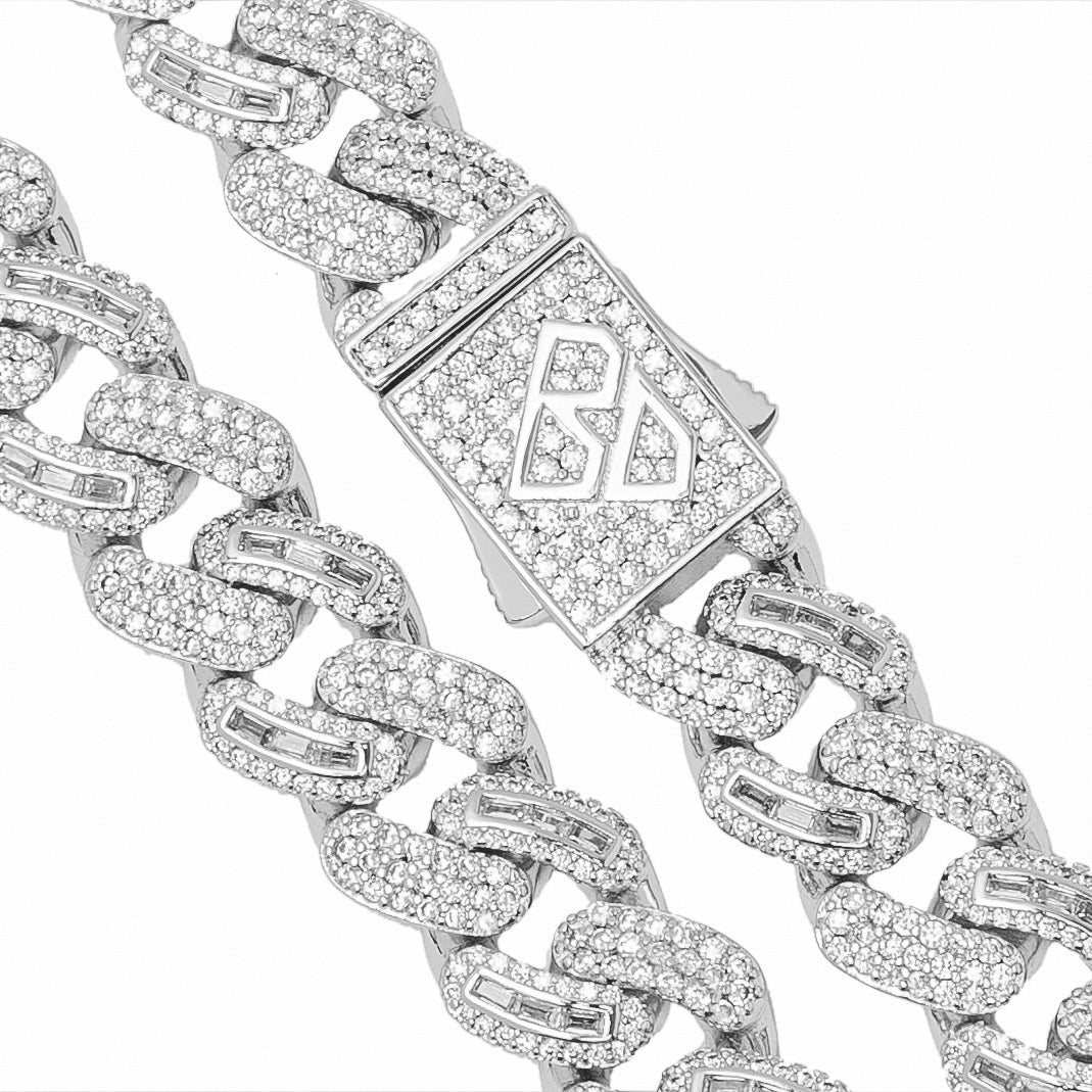 Cuban chain detail showing baguette crystal pave and decorative clasp