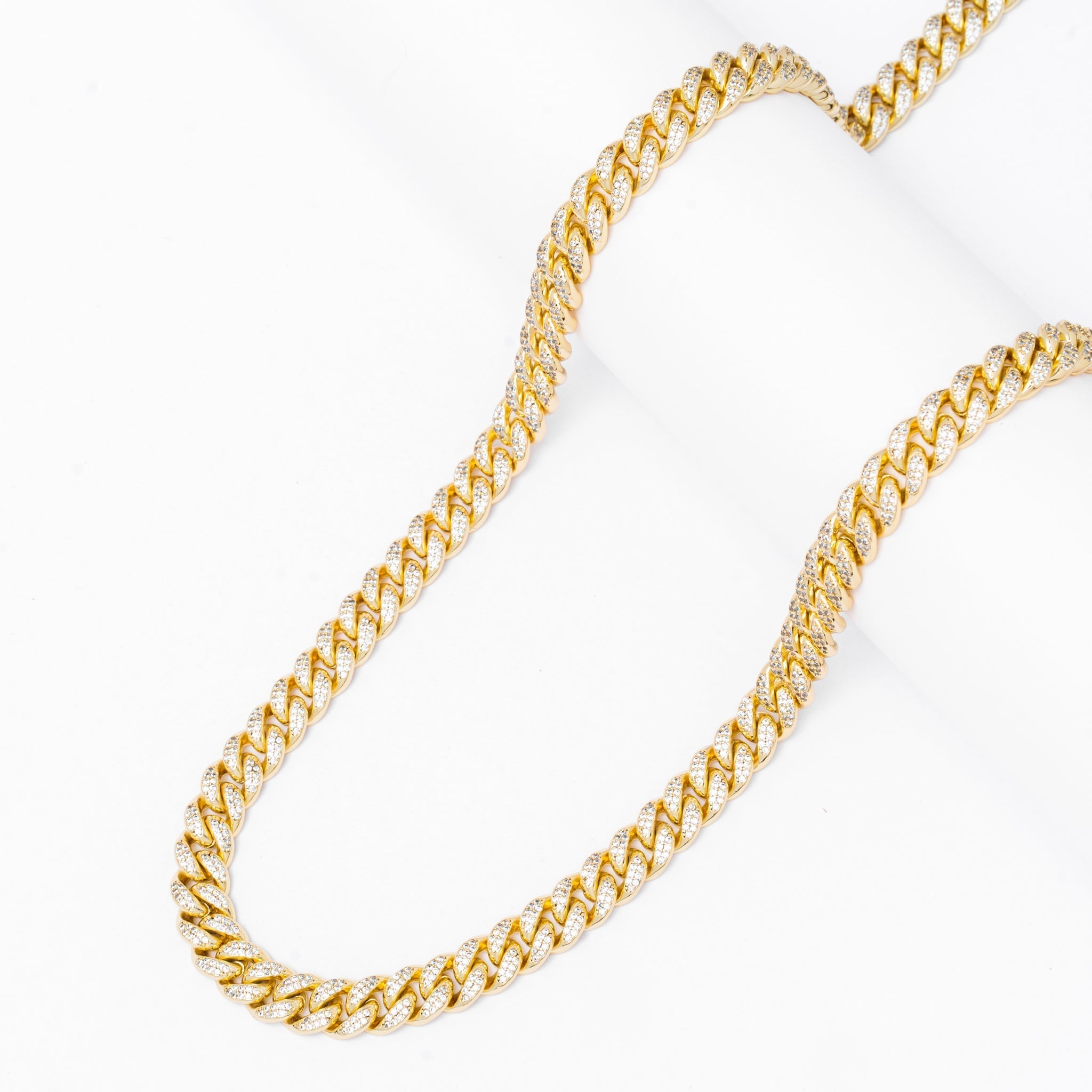 10MM iced out Cuban link gold chain curved display showing stone details