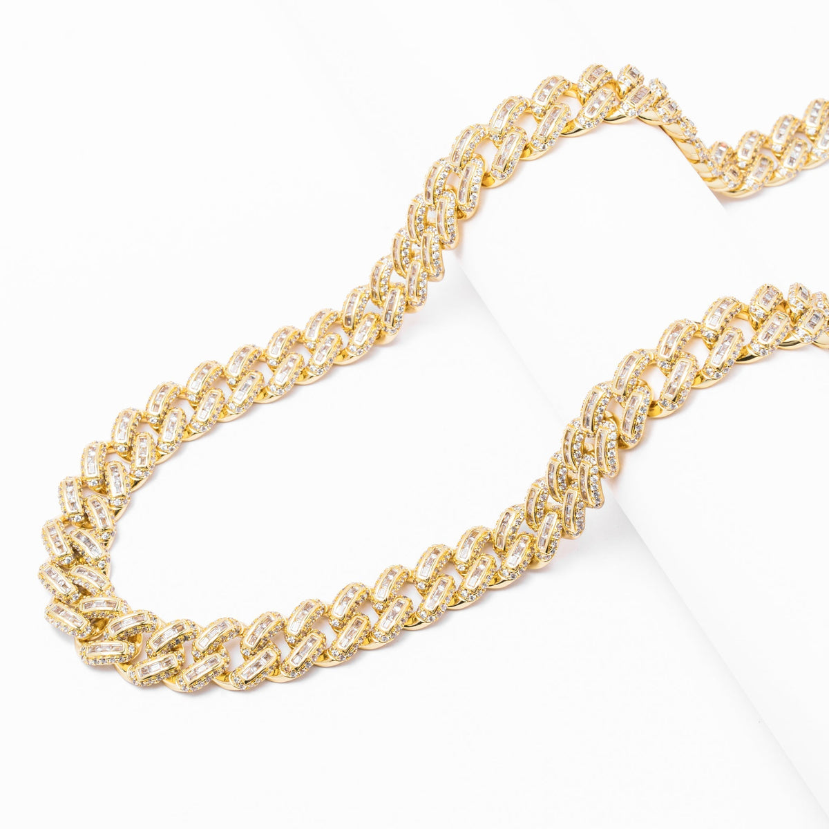 Side profile of 12MM gold Cuban link chain showing layered link structure and crystal detail